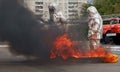 Fiteman in a fire proximity suit puts on fire.Fireman in a fire proximity suit which made to protect him from hazardous materials Royalty Free Stock Photo