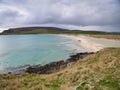 With Fitful Head in the background, the pristine, clear water of Quendale Beach in the south of Mainland, Shetland, UK