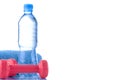 Fitnes symbols - blue dumbbells, a bottle of water and a towel. The concept of a healthy lifestyle