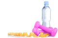 Fitnes symbols - pink dumbbells, a bottle of water and a towel. The concept of a healthy lifestyle