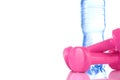 Fitnes symbols - Pink dumbbells, a bottle of water and a towel. The concept of a healthy lifestyle