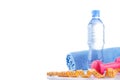 Fitnes symbols - red dumbbells, a bottle of water and a towel. The concept of a healthy lifestyle