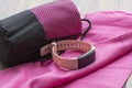 Fitness accessories. Pink microfiber towel and watch for active training and outdoor walks Royalty Free Stock Photo