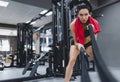 Fitness active brunette sportswoman working out in functional training gym doing crossfit exercise with battle ropes with red Royalty Free Stock Photo