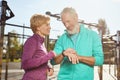 Fitness app. Happy mature family couple in sports clothing checking training results while exercising together outdoors Royalty Free Stock Photo