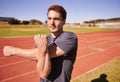 Fitness, arms and man runner stretching in stadium for race, marathon or competition training for health. Sports, vision Royalty Free Stock Photo