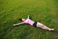 Fitness Asian Chinese woman have a rest at grass in a park Royalty Free Stock Photo