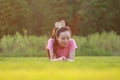 Fitness Asian Chinese woman have a rest at grass in a park Royalty Free Stock Photo