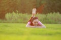 Fitness Asian Chinese woman have a rest at grass in a park Royalty Free Stock Photo