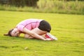 Fitness Asian Chinese woman have a rest at grass in a park Royalty Free Stock Photo