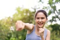 Fitness Asian Girl in tight sportswear doing exercises and punching boxing footwork cardio exercise in park. Female student boxer