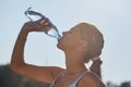 Fitness athlete woman drinking water after work out exercising on sunset evening summer in beach outdoor portrait Royalty Free Stock Photo