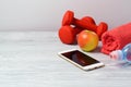 Fitness background with bottle of water, dumbbells, apple and smartphone Royalty Free Stock Photo