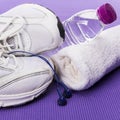 Fitness background, sneakers, headphones, water bottle and towel