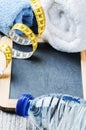 Fitness background with water bottle and towels Royalty Free Stock Photo