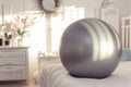 fitness ball used for leg lifts, serene bedroom environment