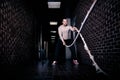 Fitness battling ropes at gym workout fitness exercise done by handsome good looking man. Crossfit battling ropes at gym workout Royalty Free Stock Photo