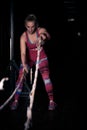 Fitness battling ropes at gym workout fitness exercise.Young woman doing some crossfit exercises with a rope at a gym