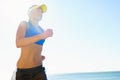 Fitness, beach and young woman running for race, competition or marathon training exercise. Sports, health and female Royalty Free Stock Photo