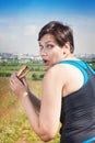 Fitness beautiful plus size woman stealthily eating junk food Royalty Free Stock Photo