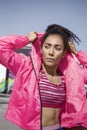 Fitness beautiful powerful young girl dressing her pink coat
