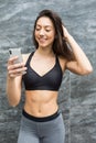 Fitness beauty woman in front of outdoors wall take selfie with Royalty Free Stock Photo