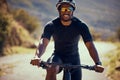 Fitness, bicycle and exercise man cycling outdoor in a street during summer with glasses and a helmet for safety. Happy Royalty Free Stock Photo