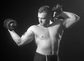 Fitness - big powerful muscular man lifting weights. Royalty Free Stock Photo