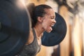Fitness, bodybuilder and shouting with a sports black woman weightlifting in a gym for a strong body. Exercise, health