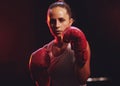Fitness, boxer and woman in sports boxing gloves training, exercise and fighting to be a young champion fighter in the