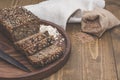 Fitness bread. A loaf of fresh rustic whole meal rye bread, sliced on a wooden board, rural food background. Top view. Copy space. Royalty Free Stock Photo