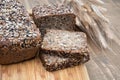 Fitness bread. A loaf of fresh rustic whole meal rye bread, sliced on a wooden board, rural food background. Close up. Royalty Free Stock Photo