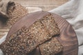 Fitness bread. A loaf of fresh rustic whole meal rye bread, sliced on a wooden board, rural food background. Top view. Royalty Free Stock Photo