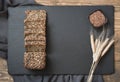 Fitness bread. A loaf of fresh rustic whole meal rye bread with wheat, sliced on a black slate dish board, rural background. Top v Royalty Free Stock Photo