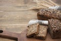 Fitness bread. A loaf of fresh rustic whole meal rye bread, sliced on a wooden board, rural food background. Copy space. Royalty Free Stock Photo