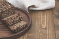 Fitness bread. A loaf of fresh rustic whole meal rye bread, sliced on a wooden board, rural food background. Top view. Fitness bre Royalty Free Stock Photo