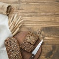 Fitness bread. A loaf of fresh rustic whole meal rye bread, sliced on a wooden board, rural food background. Top view. Copy space. Royalty Free Stock Photo