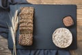 Fitness bread. A loaf of fresh rustic whole meal rye bread with wheat, sliced on a black slate dish board, food background. Top vi Royalty Free Stock Photo