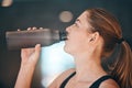 Fitness, break and woman athlete drinking water for thirst, hydration and health in a training studio. Sports, wellness Royalty Free Stock Photo