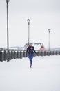 Fitness caucasian woman model running at snow winter park - sport concept Royalty Free Stock Photo