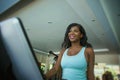 Fitness center lifestyle portrait of young happy and attractive black African American woman at gym running on treadmill machine Royalty Free Stock Photo