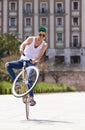 Fitness, city and man riding a bicycle and practicing tricks and skills for a competition. Activity, hobby and casual