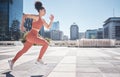 Fitness, city and woman running for exercise, health and wellness. Sports runner, energy and female athlete exercising