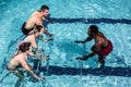 Fitness class doing aqua aerobics on exercise bikes Royalty Free Stock Photo