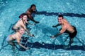 Fitness class doing aqua aerobics on exercise bikes Royalty Free Stock Photo