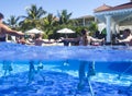 Fitness class doing aqua aerobics on exercise bikes in swimming pool resort hotel Royalty Free Stock Photo