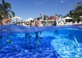 Fitness class doing aqua aerobics on exercise bikes in swimming pool resort hotel Royalty Free Stock Photo