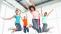 Fitness class and instructor jumping in fitness studio Royalty Free Stock Photo