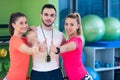 Fitness class showing thumbs up in gym