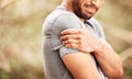 Fitness, closeup and man with shoulder pain, nature and sports with exercise, muscle tension or health issue. Zoom, male